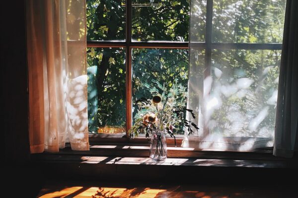 A moody photo of an indoor table and window inside Bindle Coffee.