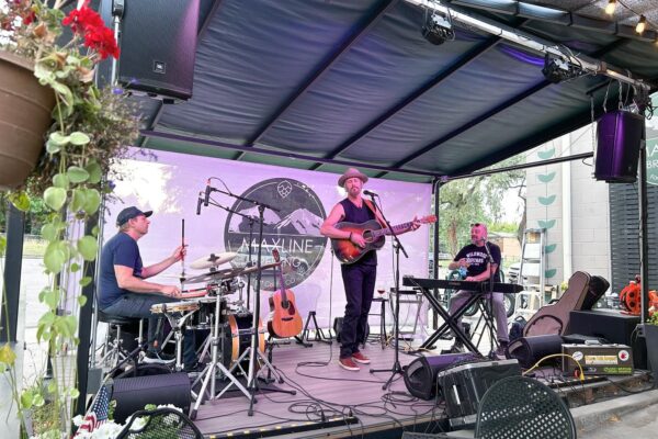A band performing live music on the stage at Maxline Brewing.